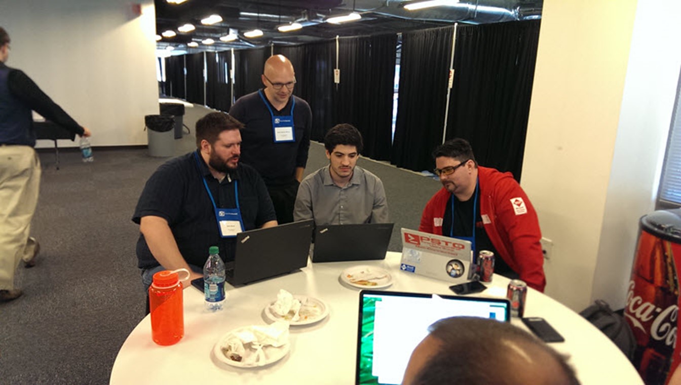 Microsoft Program Manager Joey Aiello (center) and attendees hard at it even over lunch (Image Credit: Jeff Hicks)